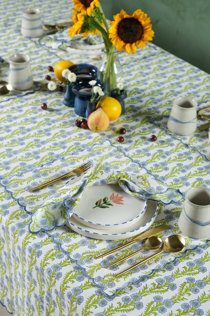 Forget-Me-Not Scalloped Cotton Placemat — close view of the mat at a coordinated floral table setting; Inner Child