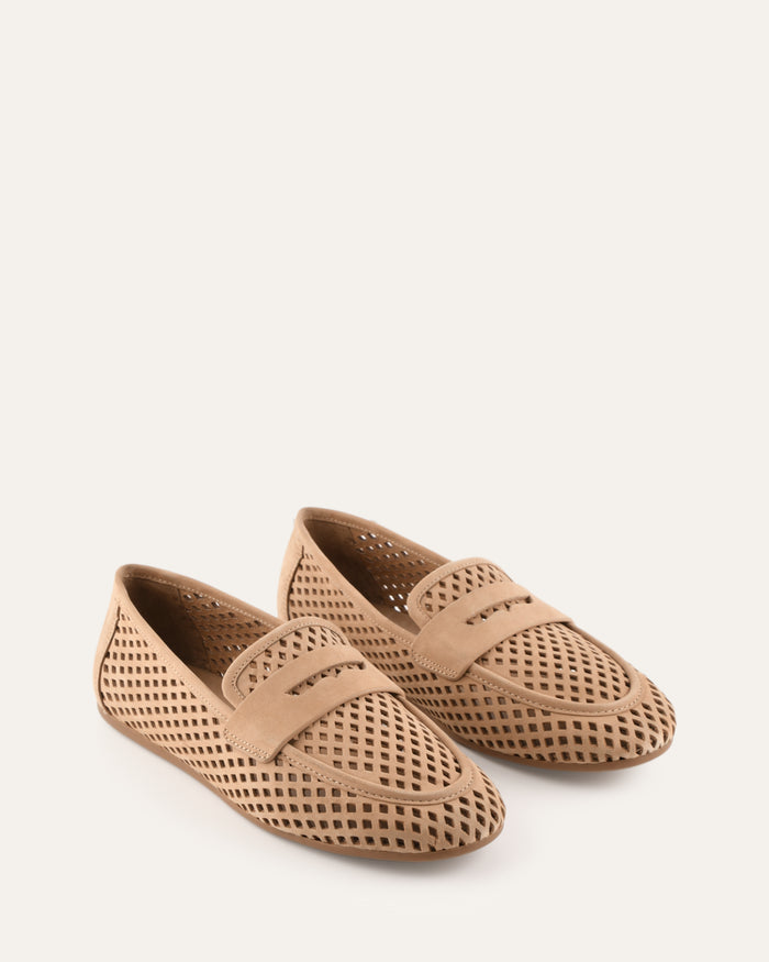 Pair of beige perforated loafers on a white background