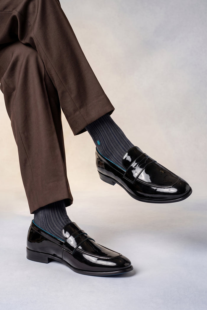 Model wearing Dayton black saddle leather loafers for men, crafted from premium leather with classic saddle design, ideal for smart casual and formal occasions.
