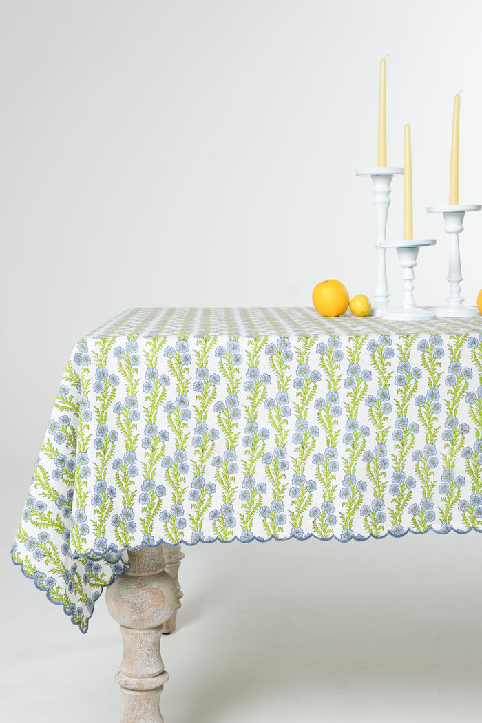 Forget-Me-Not Scalloped Blockprint Cotton Tablecloth — Forget-Me-Not tablecloth draped over a rectangular table; Inner Child