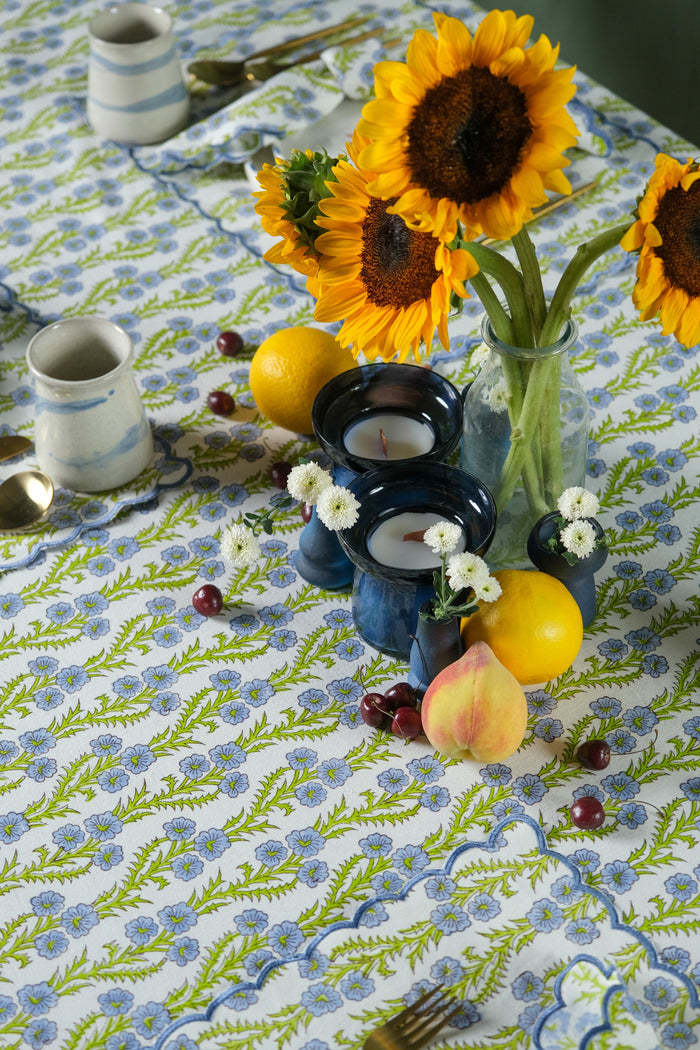 Forget-Me-Not Scalloped Blockprint Cotton Tablecloth — cloth styled with separate sunflowers and tableware; Inner Child