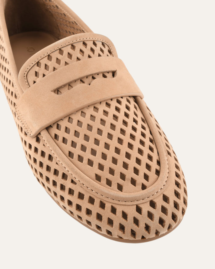 Beige loafer with perforated design on a white background
