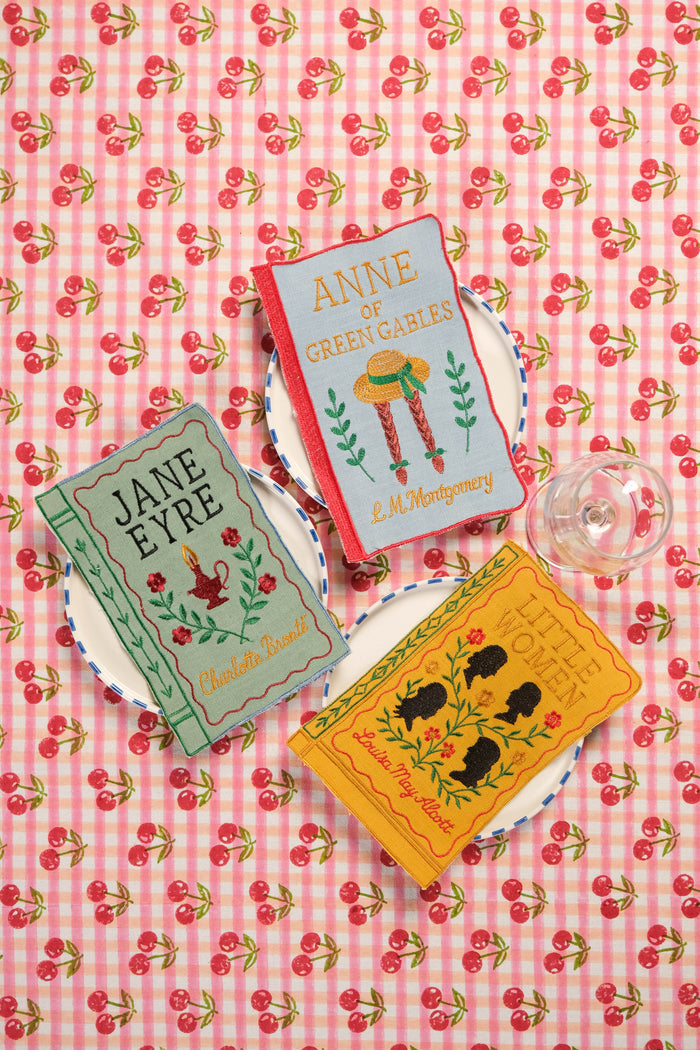 Literary Heroines Embroidered Linen-Blend Cocktail Napkins — book-inspired napkins arranged on separate floral fabric; Inner Child