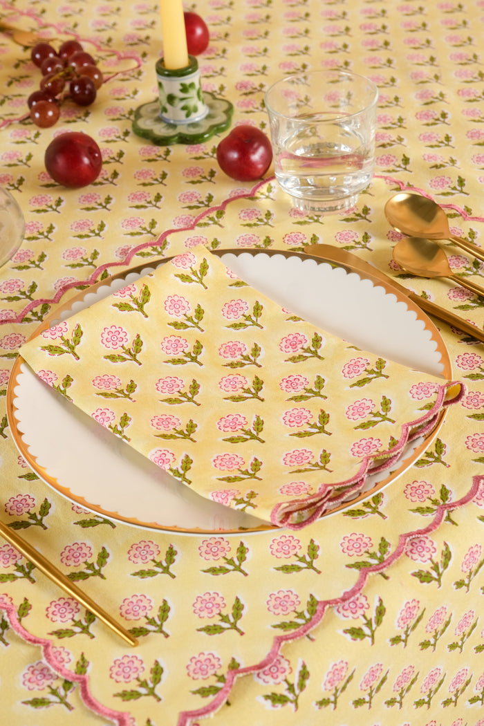 Mona Butter Yellow Scalloped Cotton Placemat — individual mat at a setting with separate fruit and glassware; Inner Child