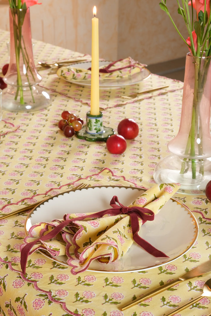 Mona Butter Yellow Scalloped Cotton Placemat — close view of the mat beneath a separate folded napkin; Inner Child
