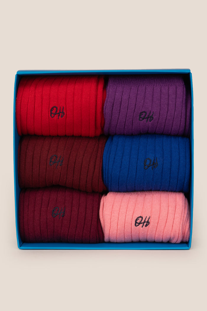 Oswin Hyde Groovy Six premium socks in bold reds, blues, and pinks, packaged in a sleek box for stylish gifting