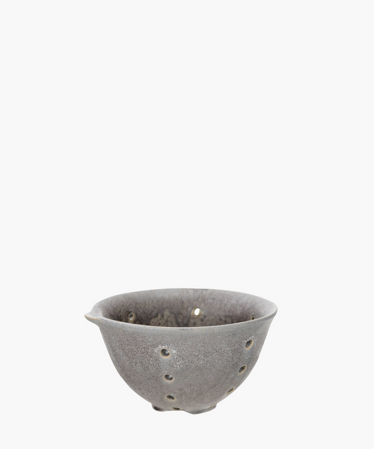 A ceramic bowl with small holes. The bowl is a textured gray. Simple and artistic. | Wildwood Home Co.