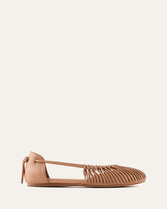 Beige flat shoe with a strap on a white background