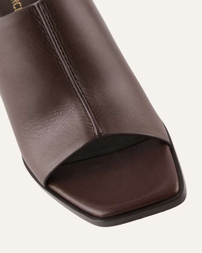 Close-up of a brown open-toe sandal on a light gray background