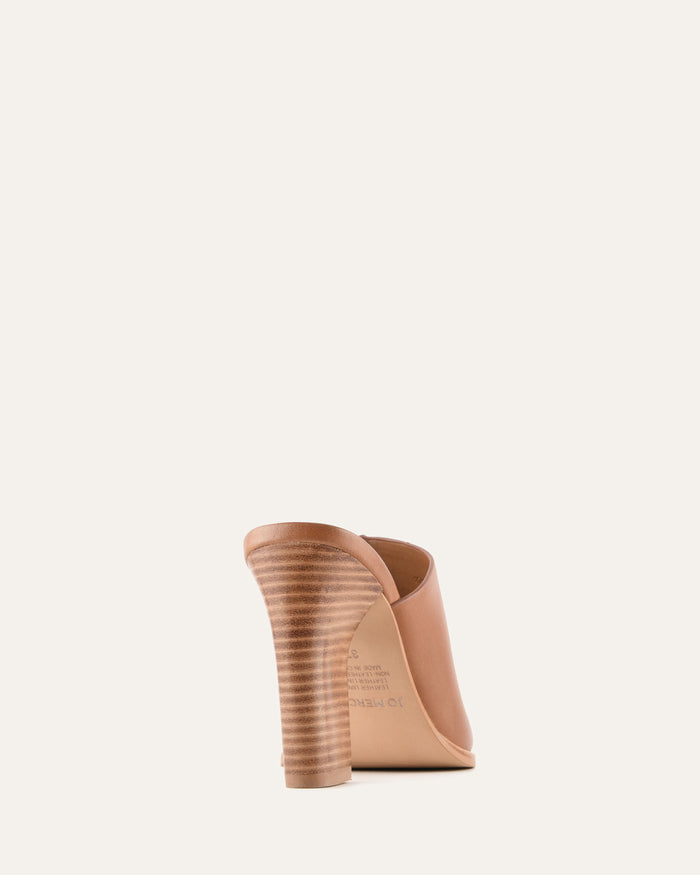 Tan wedge shoe on a light beige background