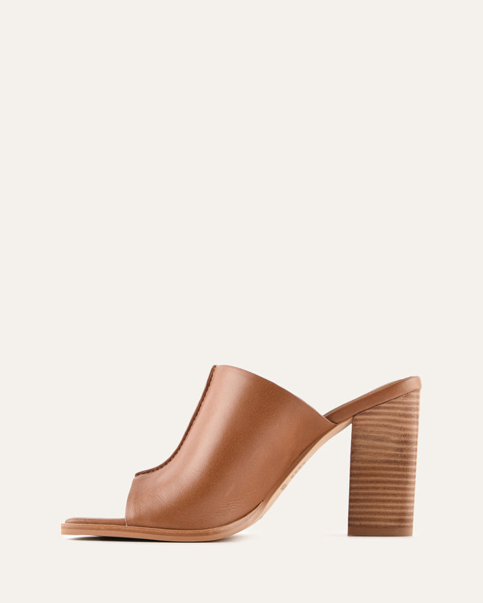 Brown open-toe sandal with a block heel on a light beige background